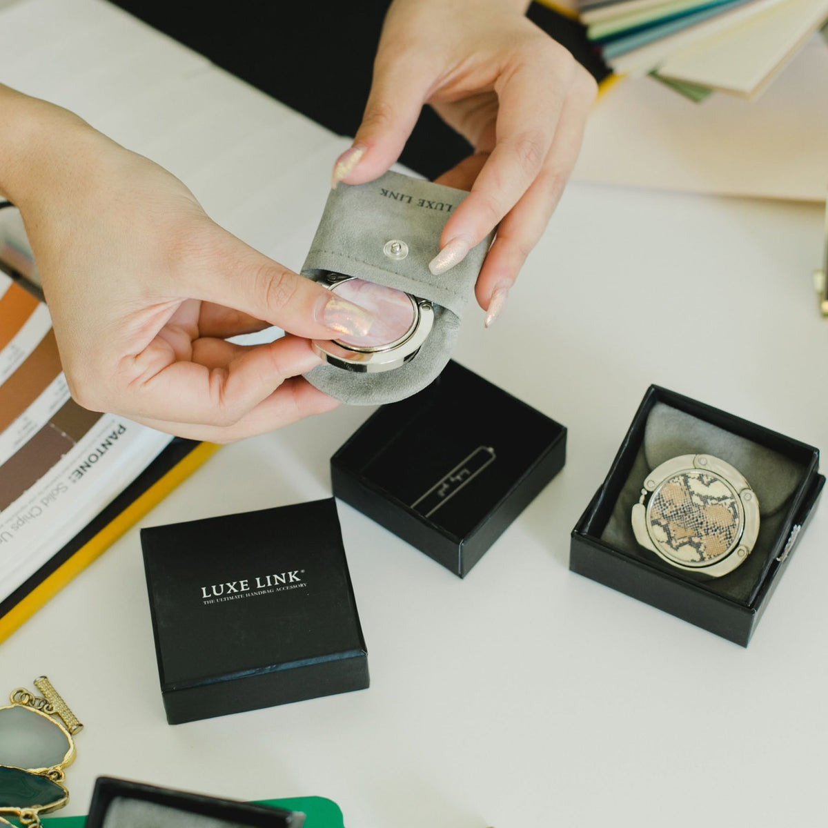 A Luxe Link hook in its open black gift box